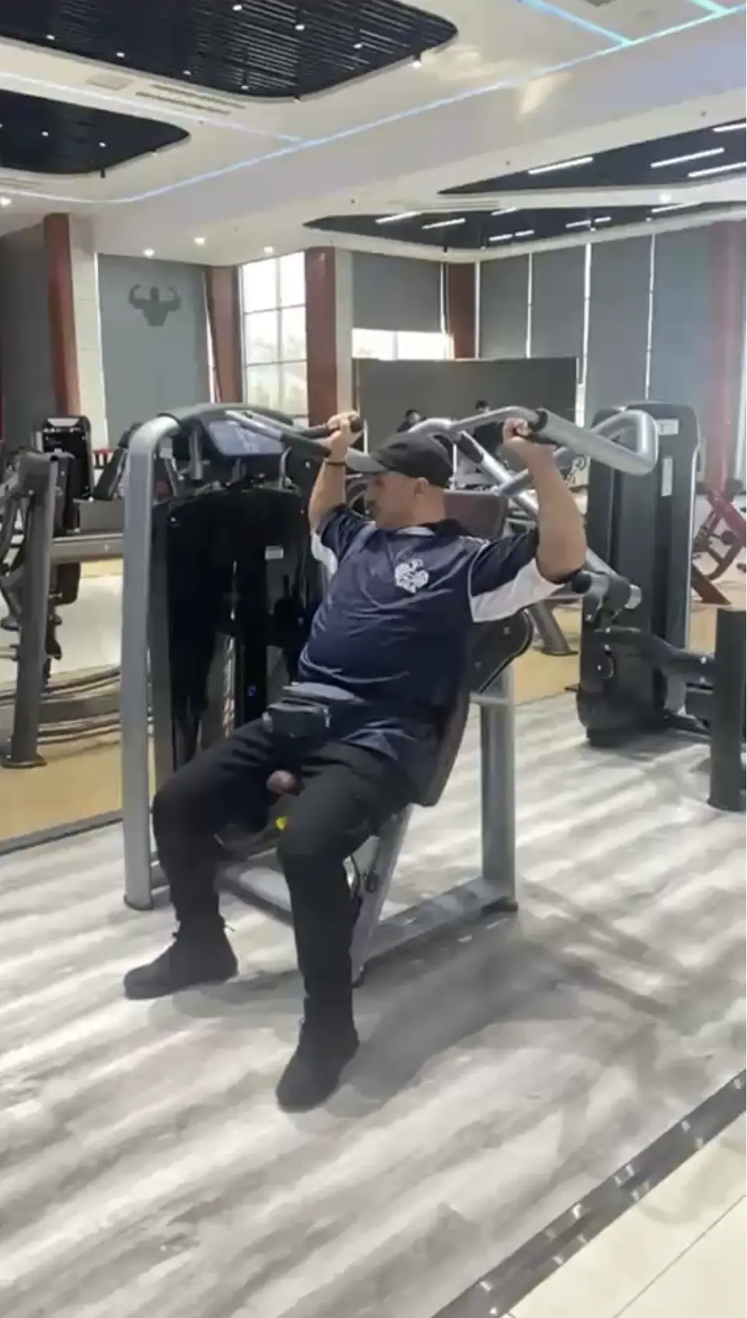 Moe inspecting gym machines in Jinan